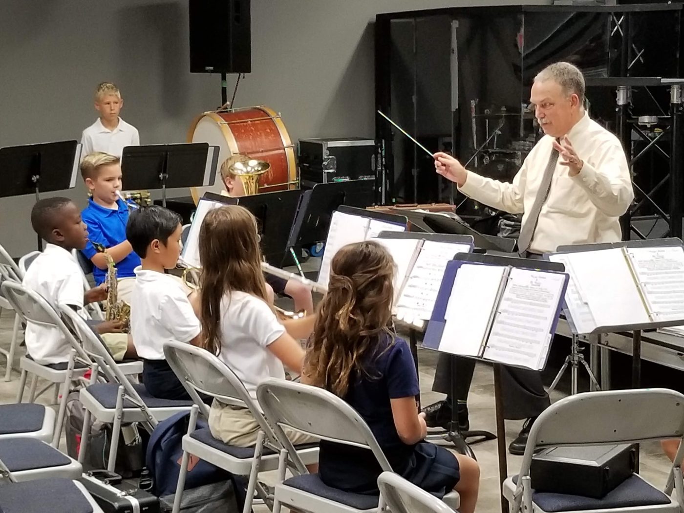 Band director rehearsing with student musicians
