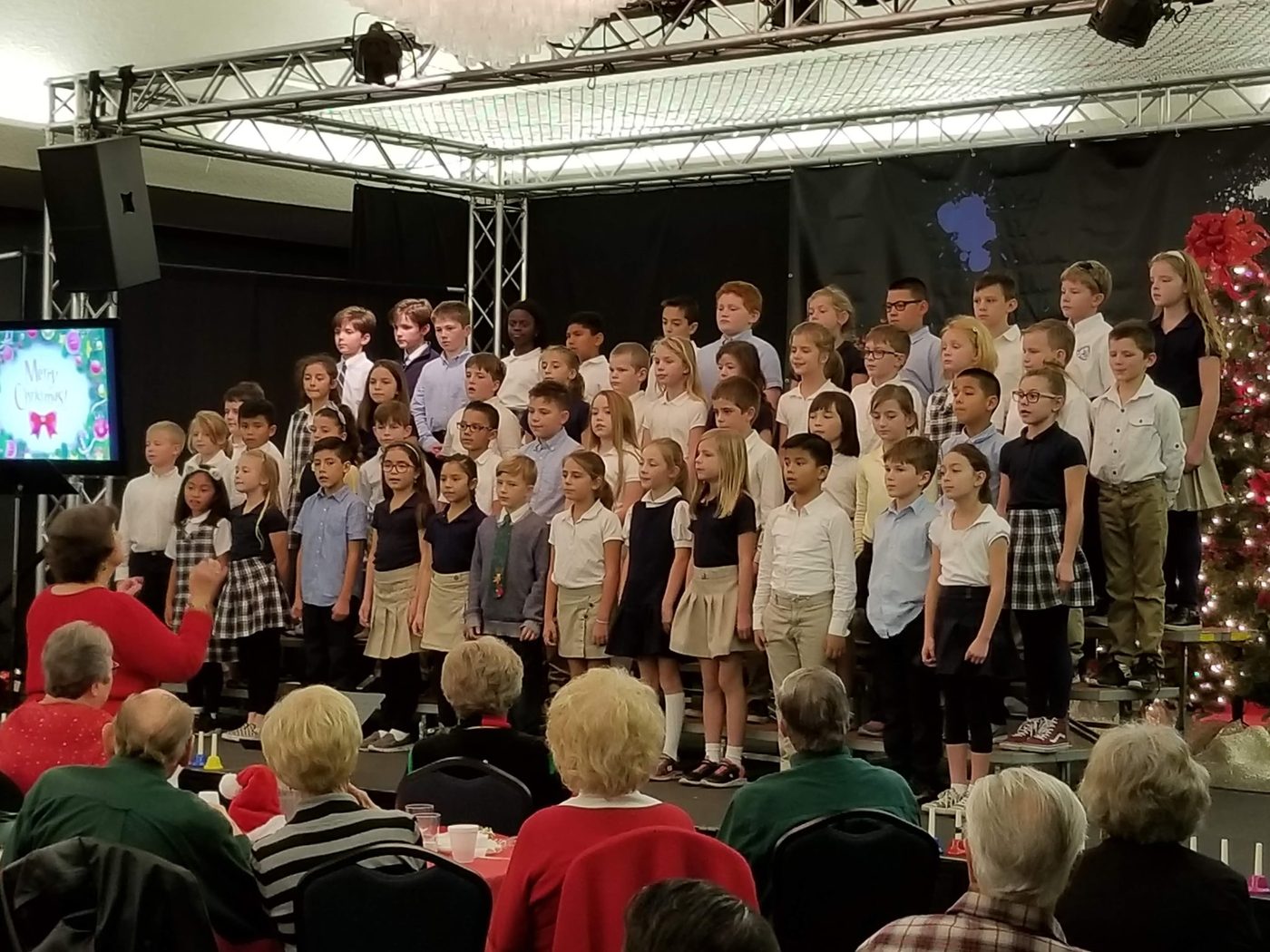 Students performing under stage lights