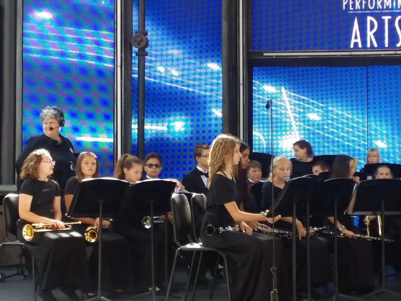 Students performing under stage lights