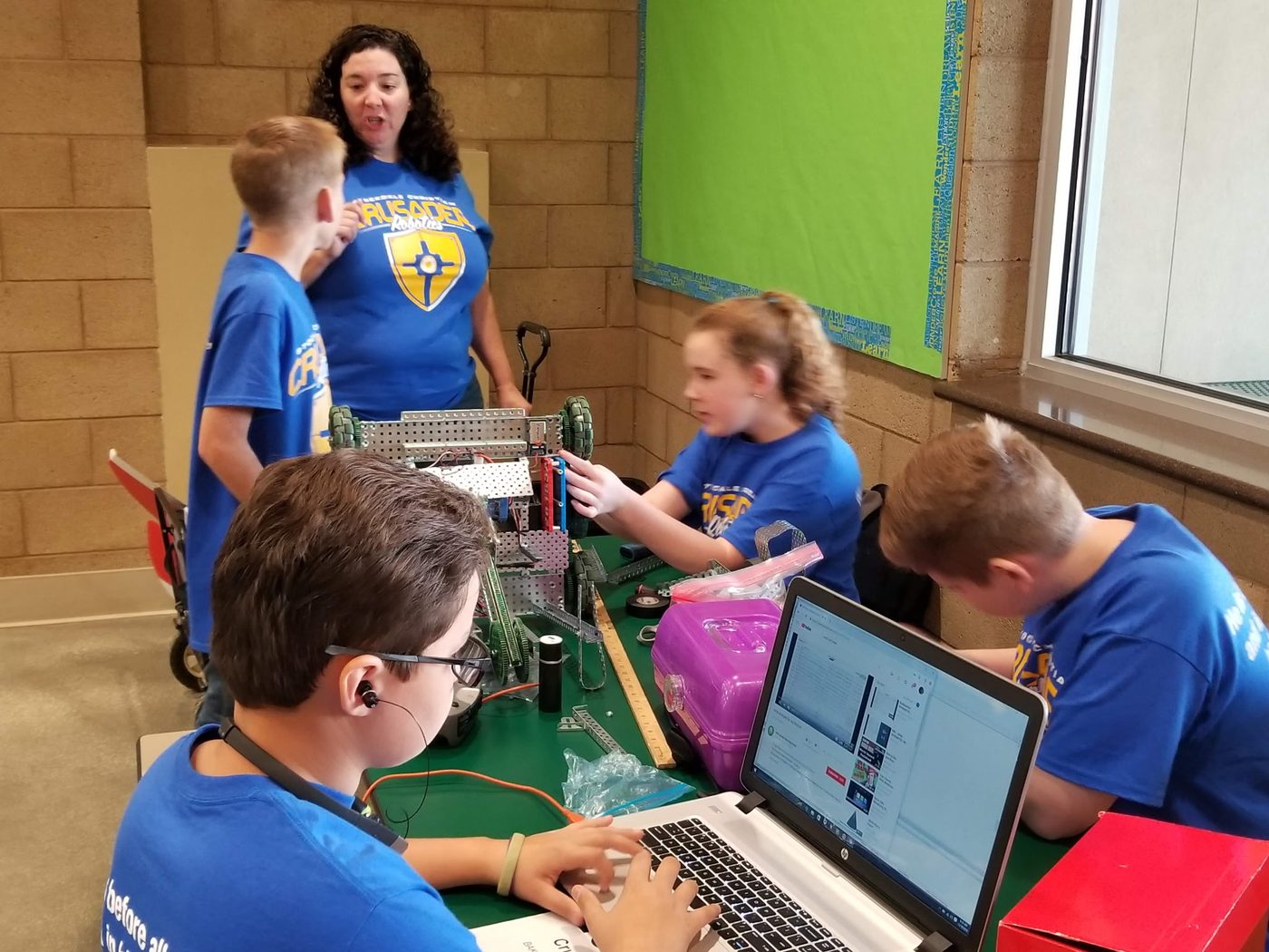 Students building a robot together