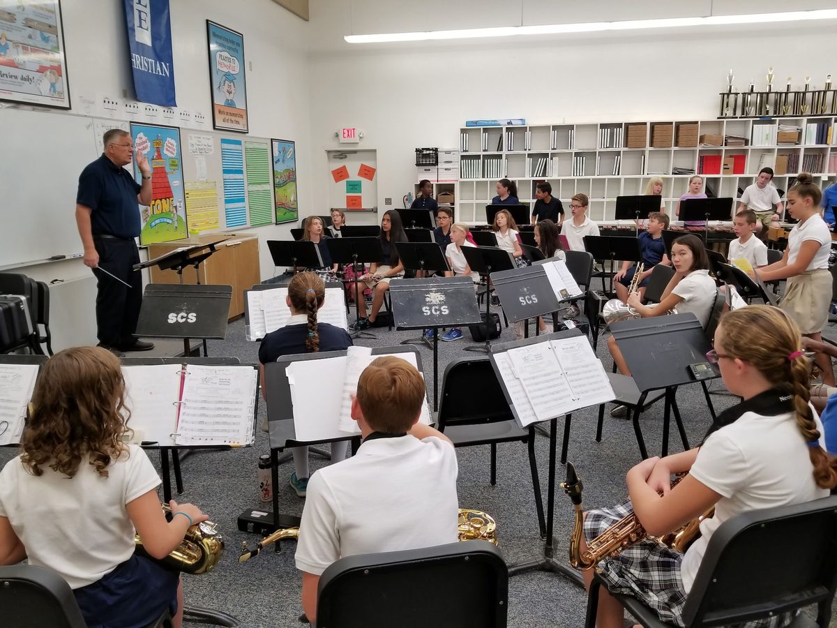 Students with instruments in the band classroom
